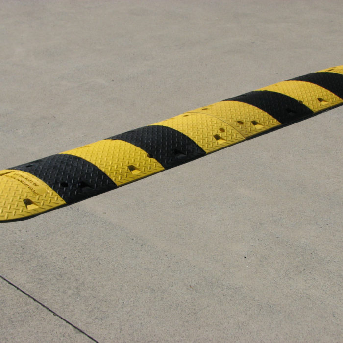 Yellow and black rubber speed hump