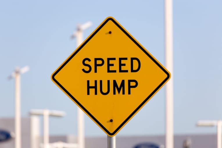 sign saying speed hump | effectiveness of speed bumps in residential neighbourhoods | speed humps australia